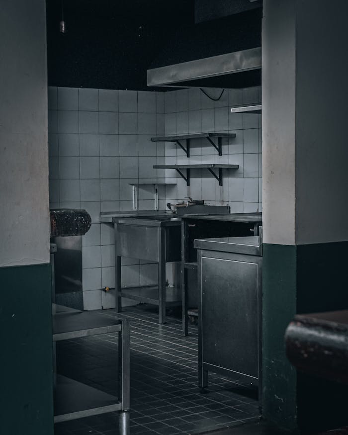 gallery-2 Moody and dark industrial kitchen space with stainless steel equipment in Madeira, Portugal.